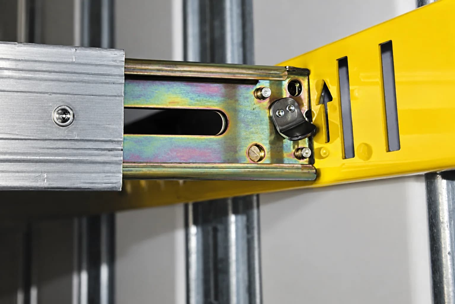 Close view of a compatible load bar fitting connected to an Exact-A-Track bracket